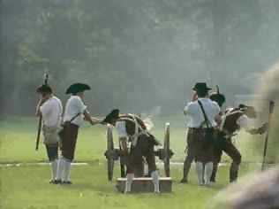 Several individuals in traditional attire participating in a historical reenactment.