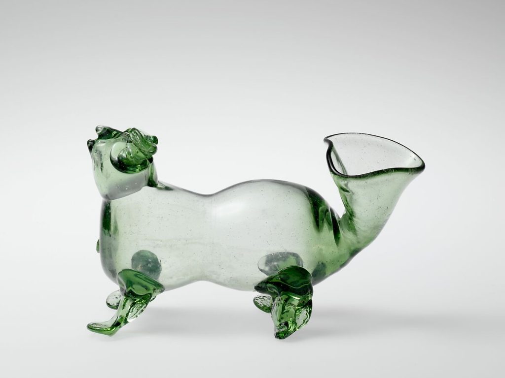 A glass drinking vessel in the shape of a dog, known as a schnapshund, produced by Wistarburg Glassworks in Alloway, New Jersey in the 18th century.